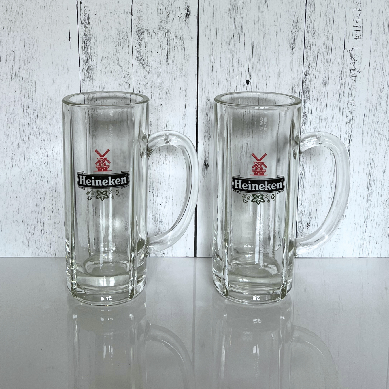 pair of vintage Heineken mugs