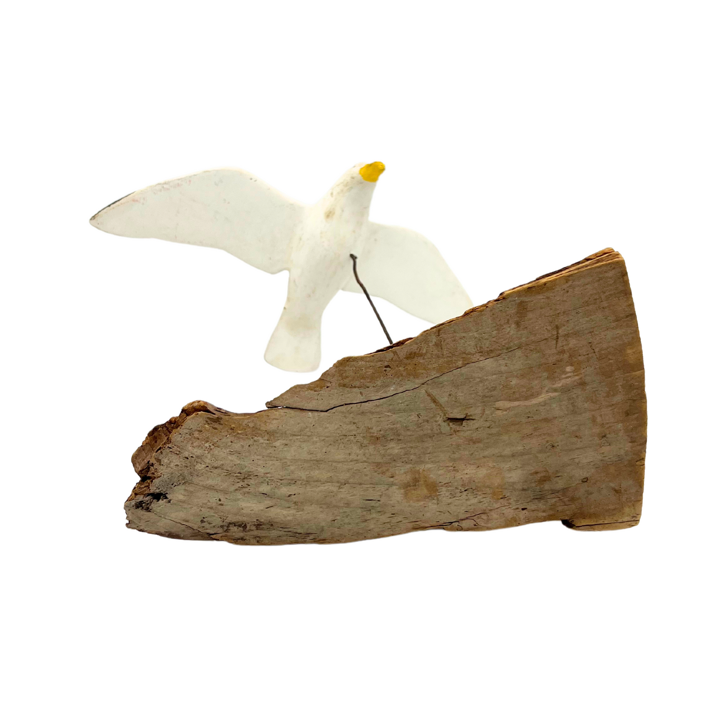 vintage handmade flying seagull over driftwood