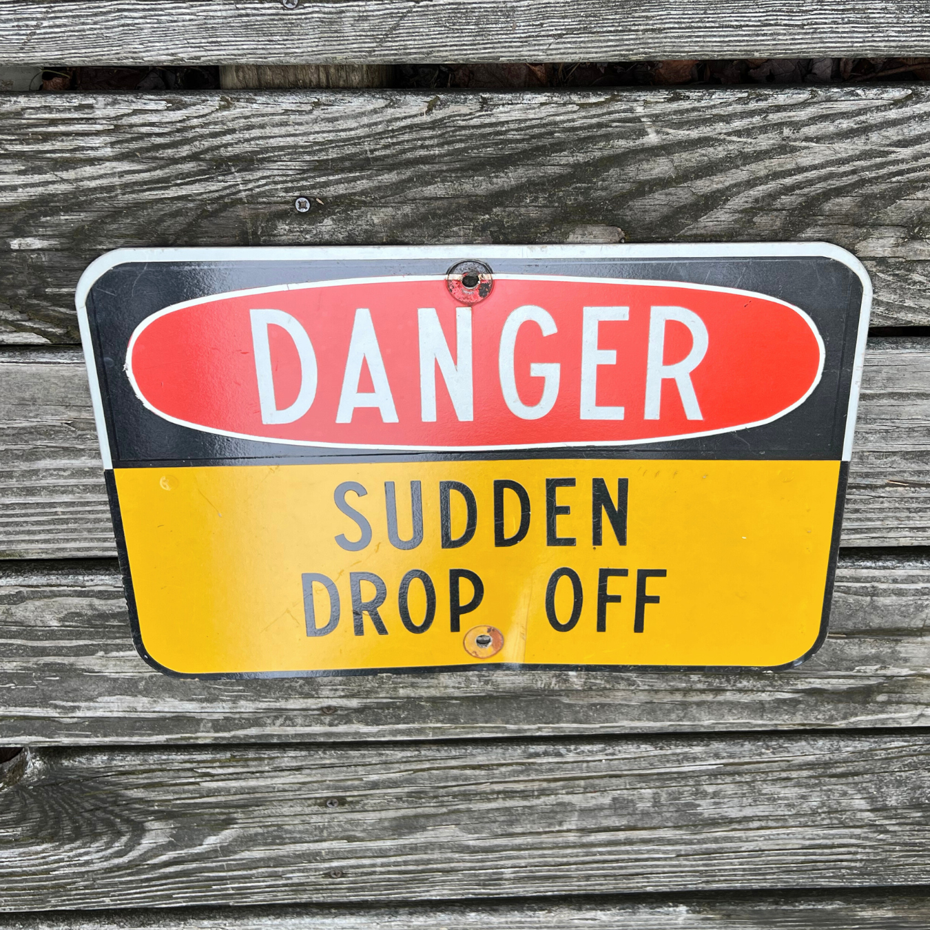 sudden drop off road sign