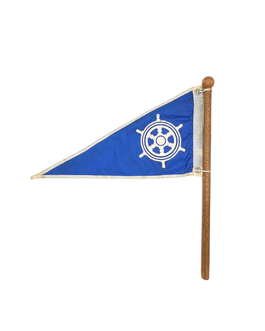 vintage ships wheel burgee on wooden pole